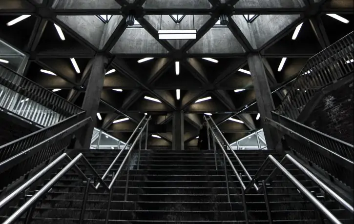 Tiled glass construction in pyramid shape lit with green-violet light